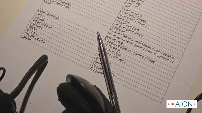 Conference interpreter's glossary for birds terminology with pen and headset