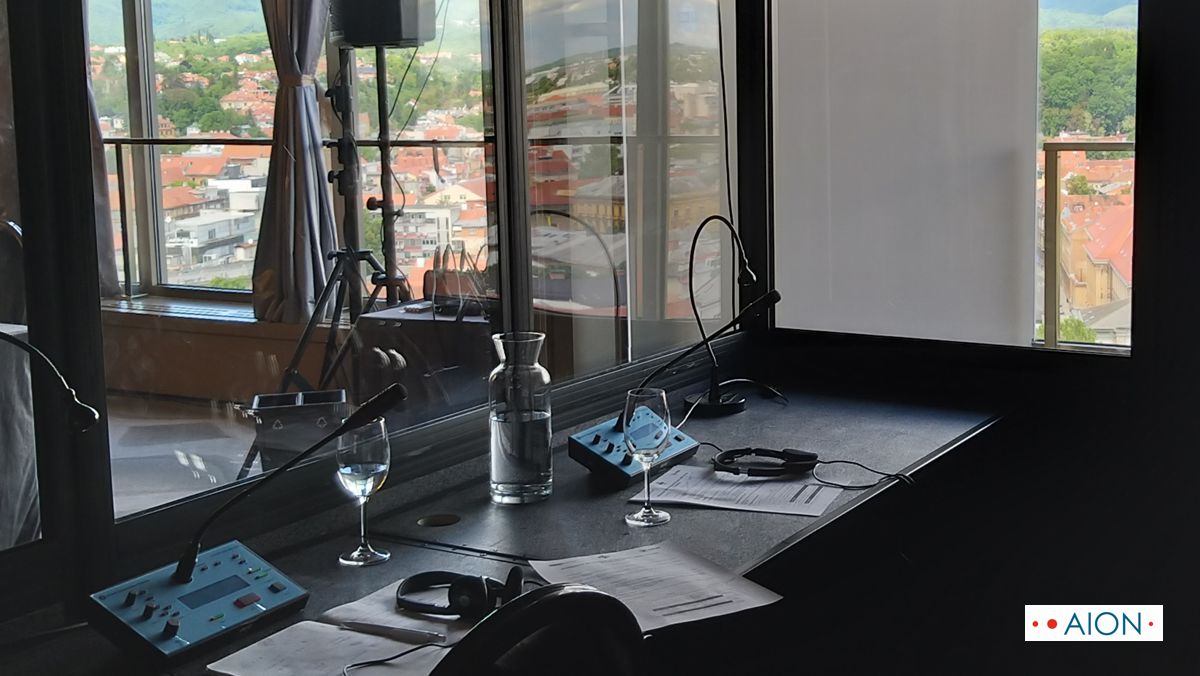 Interpreter's booth with conference equipment overlooking Zagreb rooftops and Medvednica mountain